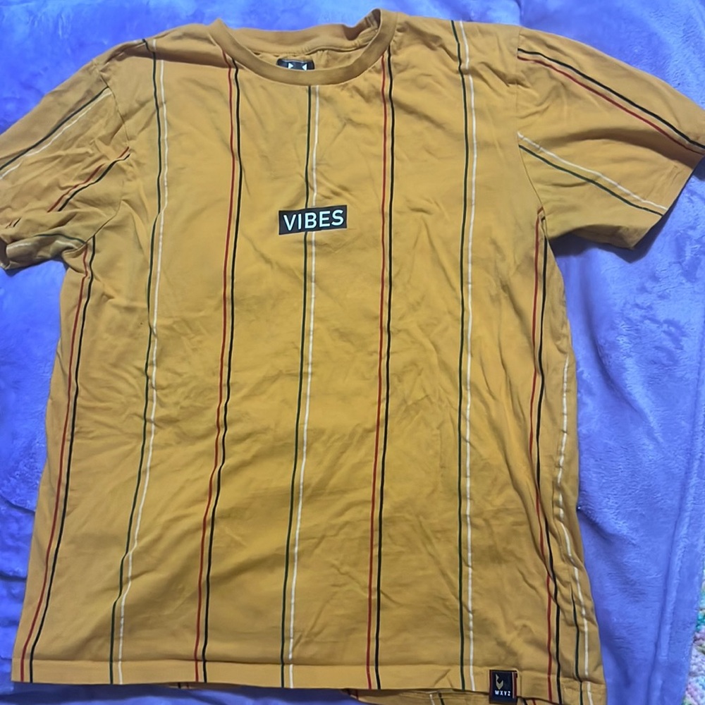 A made in India! mainly sunflower yellow T- with green, red, black,white stripes